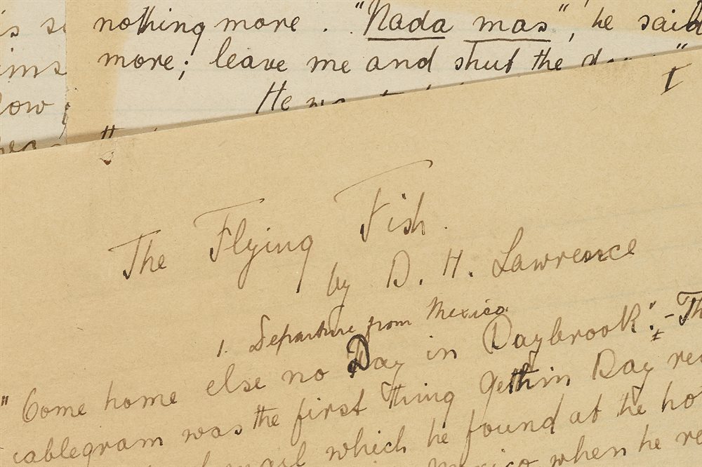 Pile of handwritten, yellowed manuscripts. The top one has the words "The Flying Fish" at the top as a title.